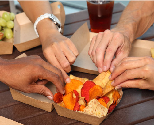 people sharing chips in Harvest Choice packaging
