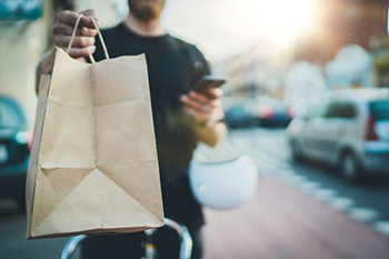 Restaurant Delivery Person Holding Takeout