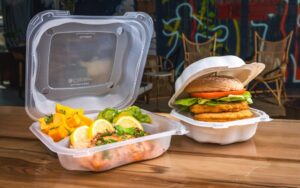 sustainable food packaging - 2 hinged containers with lunch on table