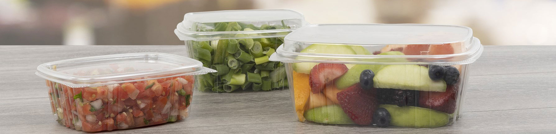 3 clear food containers filled with food and capped with lids