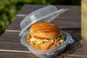 recyclable clear hinged container with chicken sandwich inside