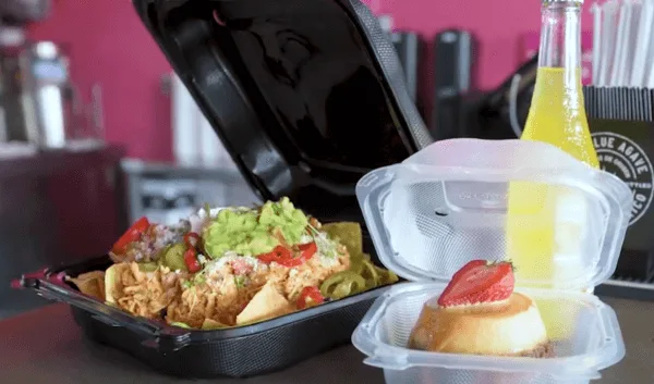 Food service containers filled with Mexican cuisine