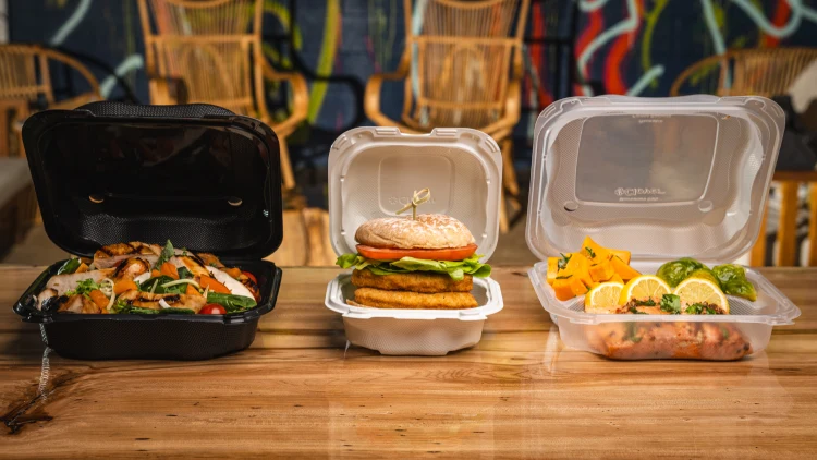 Clover hinged containers on counter with food