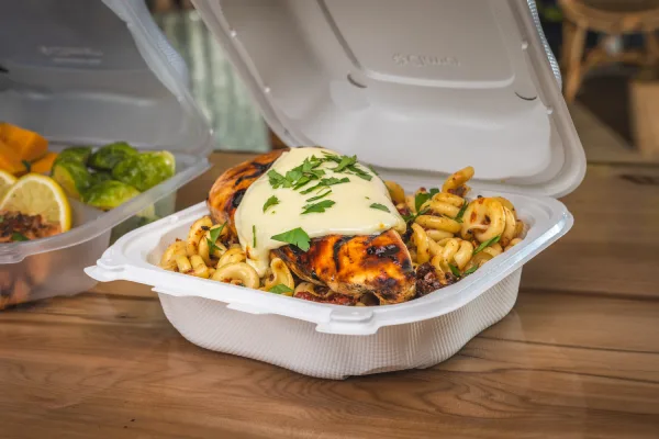 white hinged food container with chicken dish